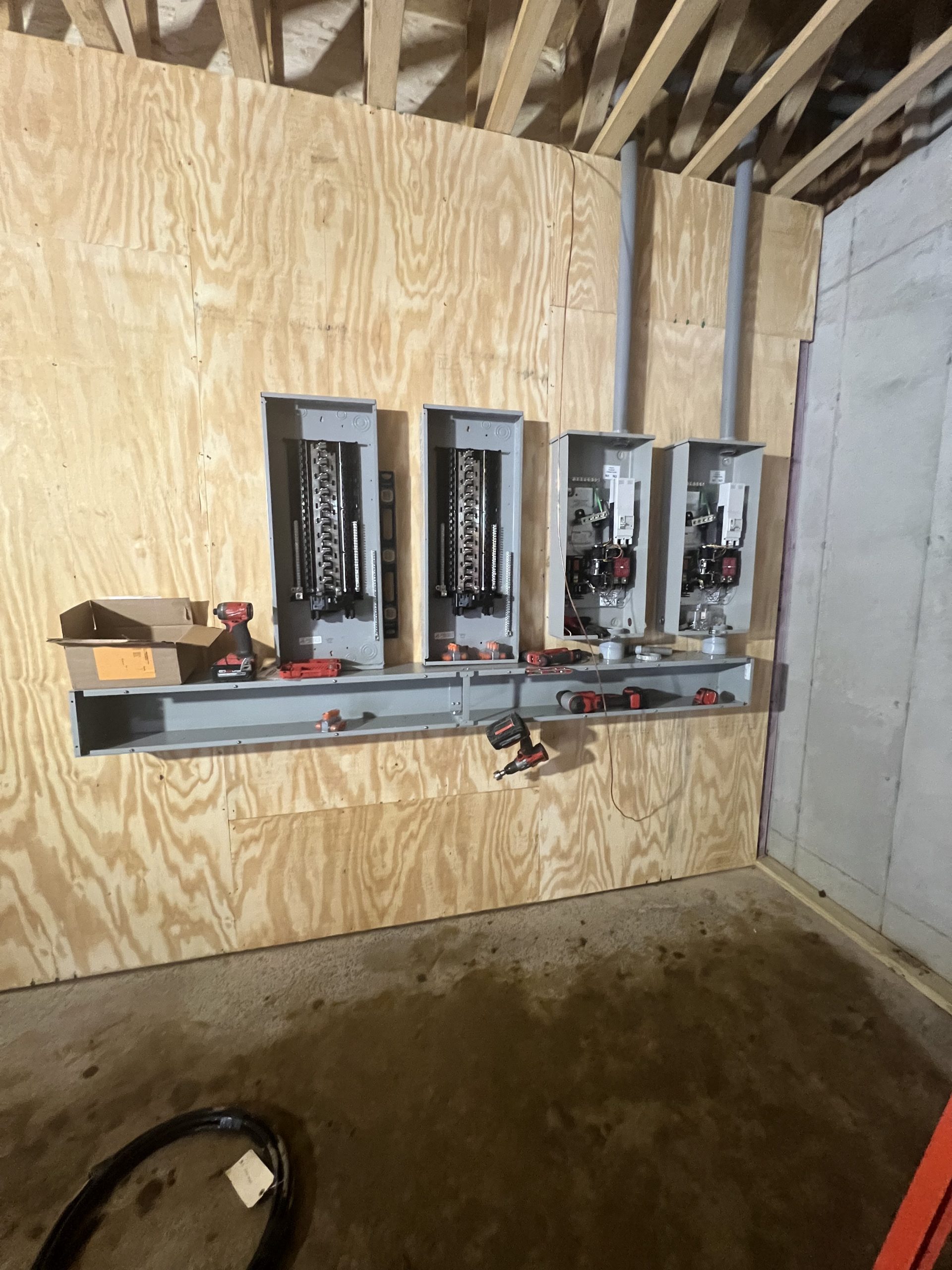Electrical panels and conduit in an unfinished building